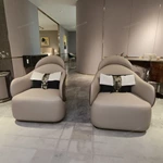 Cream Curved Leather Sofa with Dark Green Fan-Stitched Panels and Laced Edge Details